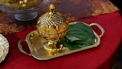 Fototapeta na wymiar TEPAK SIRIH PINANG, a gold jar to put betel and areca nut in the traditional welcoming of guests in Indonesia