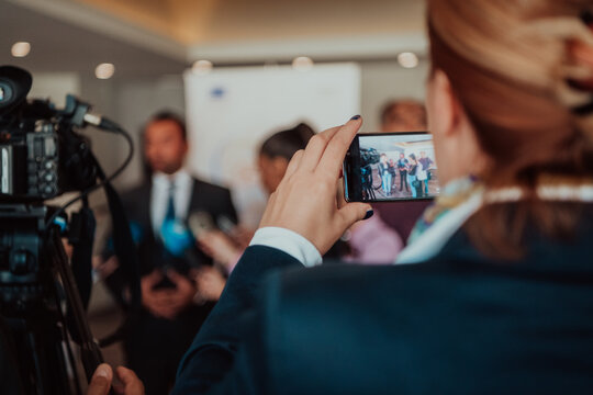 professional video production camera recording live event on stage. television social media broadcasting seminar conference.