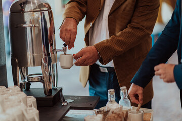 Close-up photo of businessmen serving themselves in a modern hotel during a dinner party. Selective focus 