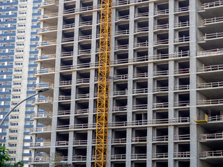 Fototapeta premium High-rise construction. Skyscraper under construction. Housing frame. Multi-apartment housing. Building cranes. Batumi. New area.