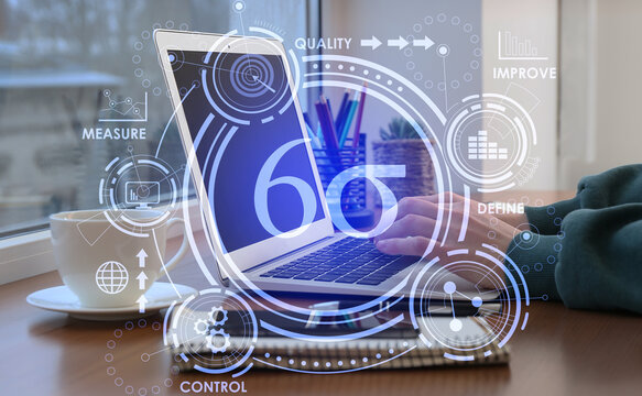 Woman with laptop in office. 6 sigma concept