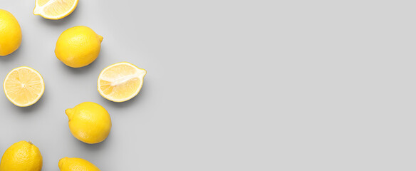 Many fresh lemons on light background with space for text, top view