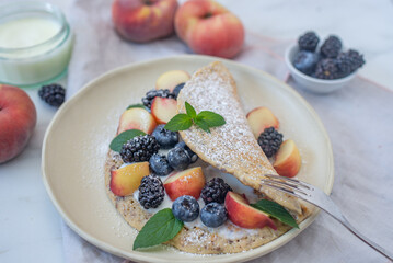 Crepes, thin pancakes or blini with berries