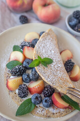 Crepes, thin pancakes or blini with berries