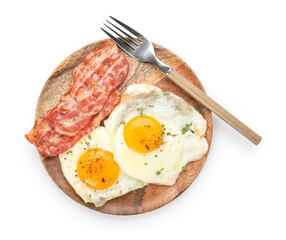 Wooden plate of tasty fried eggs with bacon on white background