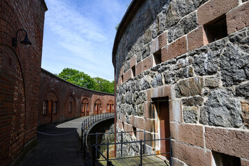 Curved stone wall with doorways and windows as a patterned background
