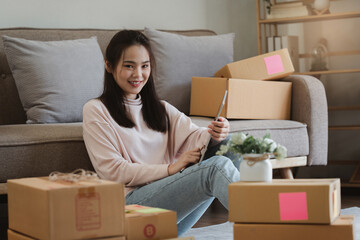 Asian SME business woman working at home office. online shopping concept