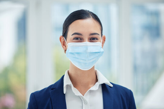 Compliance, face medical mask and covid rules at work with a business woman in corporate office. Portrait of a female worker practice social distancing at workplace, regulations and hygiene