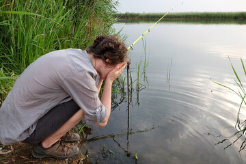 curly young girl on a fishing trip catches fish