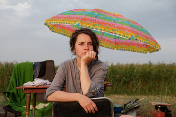 curly young girl on a fishing trip catches fish