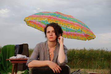 curly young girl on a fishing trip catches fish