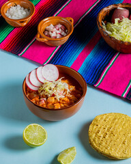clay dish with red pozole, Mexican national holidays with Mexican food, accompanied by toast, september 16