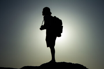 silhouette of a person on a rock