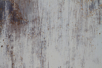 Metal rusty surface painted with white peeling paint