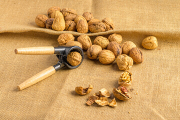 walnuts on a sackcloth and a nutcracker
