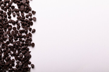 Directly above view of copy space by fresh chocolate chips on white background