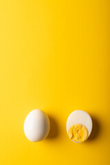 Directly above view of fresh white boiled eggs with copy space on yellow background