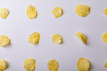 Fototapeta na wymiar Directly above shot of potato chips arranged side by side on gray background