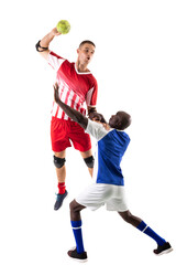 Young multiracial male athletes playing handball against white background