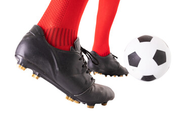 Low section of male caucasian athlete kicking soccer ball over white background