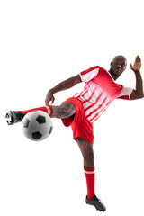 Full length of african american young male athlete kicking soccer ball against white background