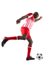 Side view of young male african american soccer player kicking ball over white background