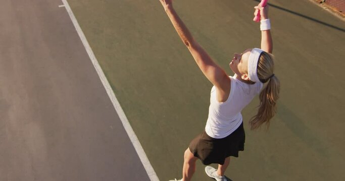 Video of top view of caucasian female tennis player holding racket and hitting ball