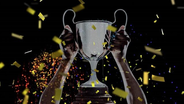 Animation of confetti falling and fireworks over caucasian man holding silver cup