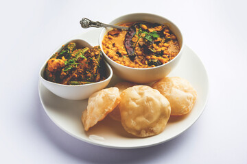 Cholar dal and patol aloo sabzi served with fried Luchi or poori, bengali food