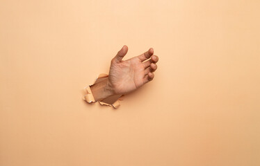 Close-up of empty man hand on brown background 