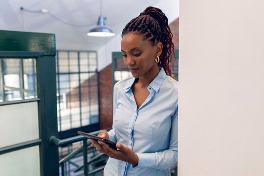 African american young businesswoman using digital tablet while standing in office