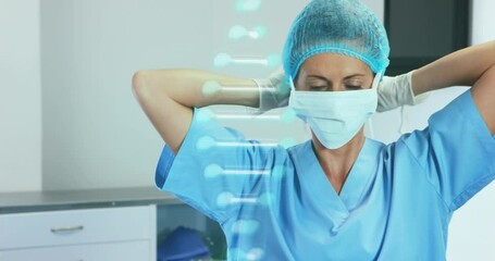 Animation of caucasian female doctor with face mask over dna strand - Powered by Adobe