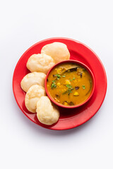 Luchi Cholar Dal or Fried bread made of flour served along with curried Chana or Bengal gram