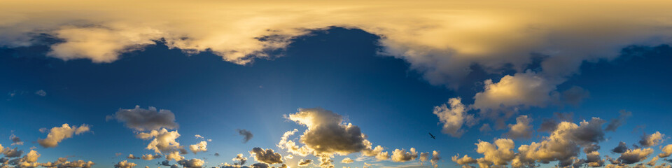 Naklejka na ściany i meble Golden glowing sunset sky panorama with Cirrus clouds. Hdr seamless spherical equirectangular 360 panorama. Sky dome or zenith for 3D visualization and sky replacement for aerial drone 360 panoramas.