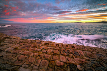sunset over tessellated pavement and sea