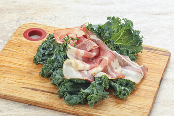 Raw pork bacon over board