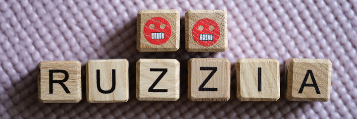 Word Russia with Z symbol on wooden cubes with angry emoticons