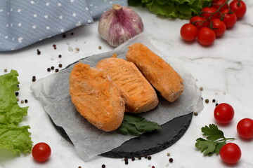 meat and vegetables on a wooden board
