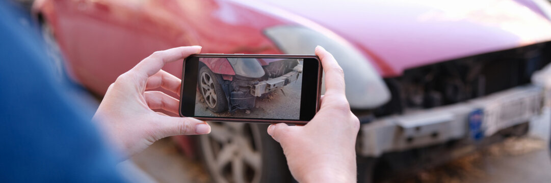 Insurance agent photographing broken car on mobile phone closeup