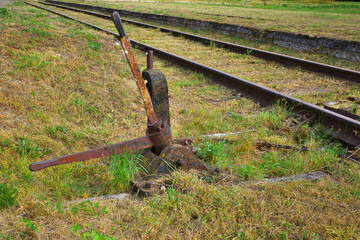 rusty railroad switch switch mechanism. abandoned railroad. Selective focus.