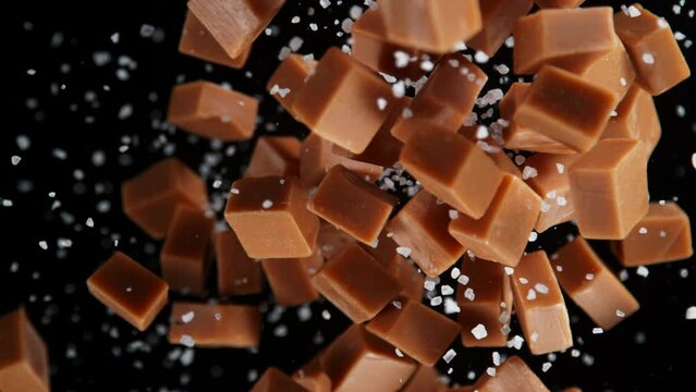 Super Slow Motion Shot of Salted Caramel Explosion Towards Camera Isolated on Black at 1000fps.