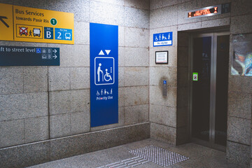 Signs priority use elevator in MRT Singapore. © 2p2play