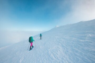 Fototapeta na wymiar two girls climb the mountain.