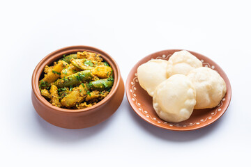 Aloo Patol sabzi made using pointed gourd and potato served with fried Luchi or poori, Bengali food