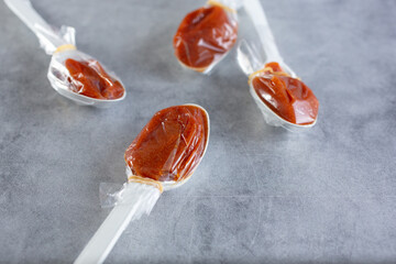 A closeup view of several tamarind candy spoons.