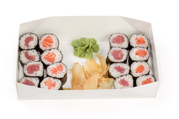 Different sushi with condiments in cardboard packaging for take-out