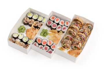 Different sushi with condiments in cardboard boxes for take-out
