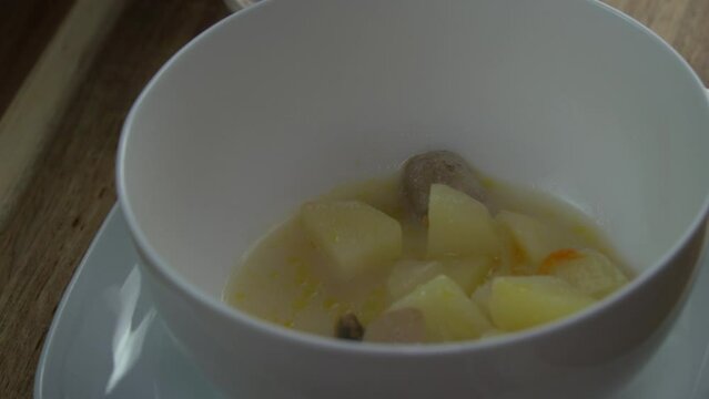 Adding Mushroom soup in a white bowl