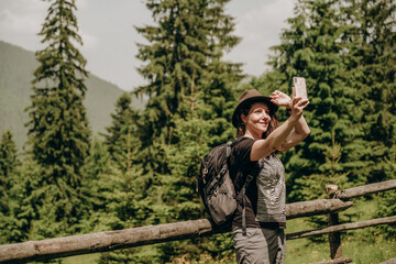 Evening walk in the countryside. A woman takes a selfie in the evening on a walk in the countryside.