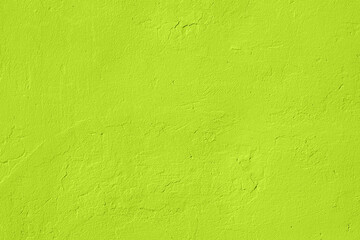 Saturated light pastel lime green colored low contrast Concrete textured background. Empty colorful...